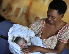 Source - © 2017 Riccardo Gangale, Courtesy of Photoshare. Description - Grace Nukayisire with her 1-day-old baby Ineza at the maternity ward in Manyange health center in Nyamata, Rwanda.